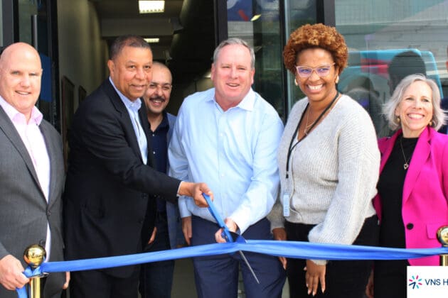 photo of John Burke and other VNS Health team members about to cut the ribbon for the Flatbush office